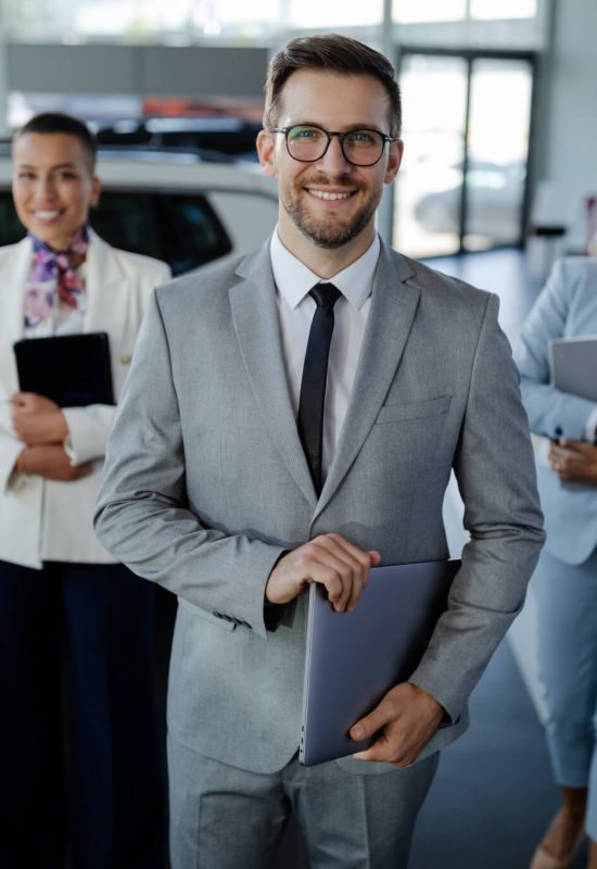 salesteam-in-dealership-three-beautiful-consultants-or-managers-in-elegant-suit-looking-on-camera-.jpg